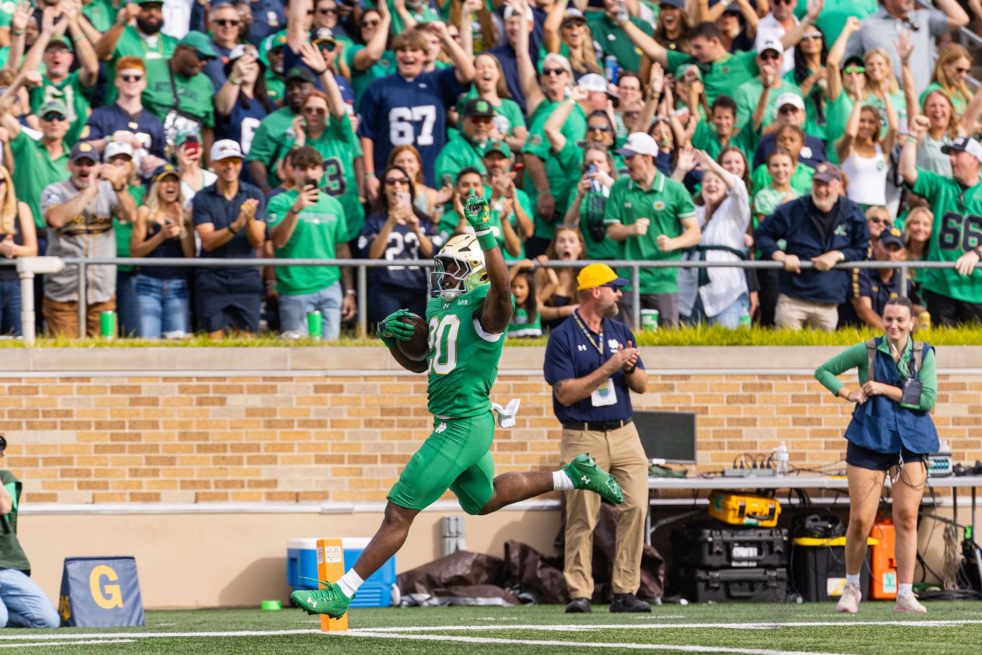 Jonaz Walton celebrates a touchdown against Stanford in a green Notre Dame uniform.